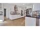 Modern white kitchen with sleek black countertops and mosaic backsplash, stainless steel appliances at 3170 Wood Springs Sw Trce, Lilburn, GA 30047