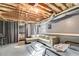 Partially finished basement area featuring exposed ceiling beams, a couch, and beds at 5998 Graywood Se Cir, Mableton, GA 30126