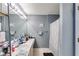 Well-lit bathroom featuring a long vanity, sink, and a shower with a decorative curtain at 5998 Graywood Se Cir, Mableton, GA 30126