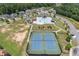 An aerial view of the community clubhouse, pool, playground, and tennis courts offering various activities at 145 Meadow Branch Ln, Dallas, GA 30157