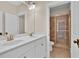 Bathroom featuring double vanity sinks, decorative lighting, and walk-in shower at 145 Meadow Branch Ln, Dallas, GA 30157