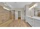 Bathroom featuring an open walk-in shower with tile surround and double sink vanity at 145 Meadow Branch Ln, Dallas, GA 30157