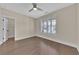 Bedroom with hardwood floors, a ceiling fan, and a window with white shutters at 145 Meadow Branch Ln, Dallas, GA 30157