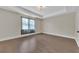 Empty bedroom with hardwood floors, tray ceiling, and a large window at 145 Meadow Branch Ln, Dallas, GA 30157