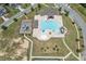 Aerial shot of a community pool with slides, playground, and lounge chairs with surrounding residential area at 145 Meadow Branch Ln, Dallas, GA 30157