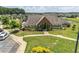 Beautiful clubhouse features a manicured lawn, decorative trees, and convenient parking at 145 Meadow Branch Ln, Dallas, GA 30157