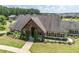Exterior view of the clubhouse with an inviting entrance and beautifully maintained landscaping at 145 Meadow Branch Ln, Dallas, GA 30157