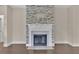 Modern fireplace with stone surround and white mantel at 145 Meadow Branch Ln, Dallas, GA 30157