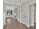 Hallway with hardwood floors, white trim, leading to an open living space with a stone fireplace at 145 Meadow Branch Ln, Dallas, GA 30157