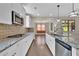 Gourmet kitchen with granite countertops, stainless steel appliances, and modern cabinetry at 145 Meadow Branch Ln, Dallas, GA 30157
