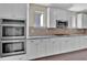 Modern kitchen with double oven, stainless steel appliances, and ample counter space at 145 Meadow Branch Ln, Dallas, GA 30157