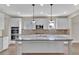 Gourmet kitchen island with granite countertops and stainless steel appliances at 145 Meadow Branch Ln, Dallas, GA 30157