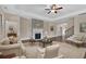 Cozy living room featuring hardwood floors, a stone fireplace, comfortable seating, and an elegant area rug at 145 Meadow Branch Ln, Dallas, GA 30157