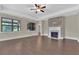 Large open living room with hardwood floors, a stone fireplace, and plenty of natural light at 145 Meadow Branch Ln, Dallas, GA 30157