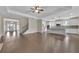 Open concept living space with hardwood floors, a staircase, and a view of the modern kitchen at 145 Meadow Branch Ln, Dallas, GA 30157