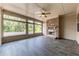 Cozy screened patio boasts a stone fireplace, ceiling fan, and backyard views at 145 Meadow Branch Ln, Dallas, GA 30157