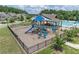 Community playground features a slide, swings, and climbing structures with a covered picnic area and pool nearby at 145 Meadow Branch Ln, Dallas, GA 30157