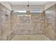 Walk-in shower featuring decorative tile surround, built-in shower bench, and dual shower heads at 145 Meadow Branch Ln, Dallas, GA 30157