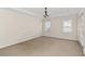 Spacious bedroom with neutral carpeting and natural light from two windows at 1880 Eastfield St, Decatur, GA 30032