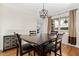 Dining room with modern light fixture, hardwood floors, and a view to the exterior at 1880 Eastfield St, Decatur, GA 30032