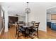 Open dining area with hardwood floors, decorative chandelier, and access to living room and kitchen at 1880 Eastfield St, Decatur, GA 30032