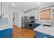 Modern kitchen boasts stainless steel appliances, stylish tile backsplash, and blue lower cabinets at 1880 Eastfield St, Decatur, GA 30032