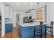 Bright kitchen features an island with bar seating, stainless steel appliances, and modern pendant lighting at 1880 Eastfield St, Decatur, GA 30032