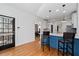 Charming kitchen featuring a blue island with seating, hardwood floors, and modern pendant lighting at 1880 Eastfield St, Decatur, GA 30032