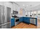 Bright kitchen with stainless steel appliances, blue lower cabinets and ample natural light from large windows at 1880 Eastfield St, Decatur, GA 30032