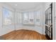 Bright living room featuring hardwood floors, large windows with blinds, and white trim at 1880 Eastfield St, Decatur, GA 30032