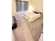 Cozy bedroom featuring a large window and neutral carpet at 7157 Gladstone Cir, Stonecrest, GA 30038