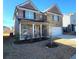 Charming two-story brick home featuring a manicured lawn and attached garage at 7157 Gladstone Cir, Stonecrest, GA 30038
