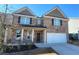 Charming two-story brick home featuring a two-car garage and inviting front porch at 7157 Gladstone Cir, Stonecrest, GA 30038