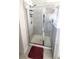 Tiled shower with glass door and modern fixtures at 7157 Gladstone Cir, Stonecrest, GA 30038