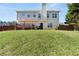 The backyard features a lush green lawn, a wooden deck, and a privacy fence at 7235 Magnolia Ln, Fairburn, GA 30213