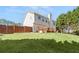 Large grassy backyard with a wooden deck and a privacy fence at 7235 Magnolia Ln, Fairburn, GA 30213