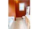 Bathroom showcasing a soaking tub, toilet, and wood vanity at 7235 Magnolia Ln, Fairburn, GA 30213