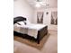 Neutral bedroom with large bed, two windows, and a ceiling fan at 7235 Magnolia Ln, Fairburn, GA 30213