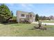 View of home with landscaping, a driveway, a two-car garage, and lawn at 7235 Magnolia Ln, Fairburn, GA 30213