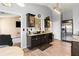 Open kitchen with stainless steel refrigerator, granite countertops, and dark cabinetry at 7235 Magnolia Ln, Fairburn, GA 30213