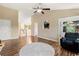 Living room with high ceilings, wood floors, and views into the kitchen and foyer at 7235 Magnolia Ln, Fairburn, GA 30213