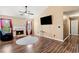 Cozy living room featuring wood flooring, a fireplace, a ceiling fan, and natural light at 7235 Magnolia Ln, Fairburn, GA 30213