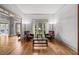 Inviting living room featuring hardwood floors, natural light, and a comfortable seating arrangement at 6289 Grand Loop Rd, Sugar Hill, GA 30518