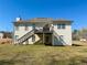 Back exterior of the house with a wooden deck and a grassy yard at 226 Saul Dr, Ellenwood, GA 30294