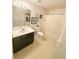 Bright bathroom features a vanity with dark cabinets and shower with white curtain at 226 Saul Dr, Ellenwood, GA 30294