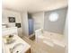 Bathroom featuring a soaker tub, tiled floors, vanity with sink, and a window for natural light at 226 Saul Dr, Ellenwood, GA 30294