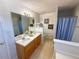 Bathroom features a double sink vanity, a large mirror, and a shower with a blue curtain at 226 Saul Dr, Ellenwood, GA 30294