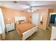 Bedroom featuring carpeted floors, a ceiling fan, neutral walls, and a white bedside table at 226 Saul Dr, Ellenwood, GA 30294