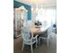 Refined dining room with elegant white chairs, a white hutch and decorative chandelier with natural light at 226 Saul Dr, Ellenwood, GA 30294