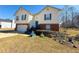 View of a two-story home with tidy lawn and landscaping features at 226 Saul Dr, Ellenwood, GA 30294